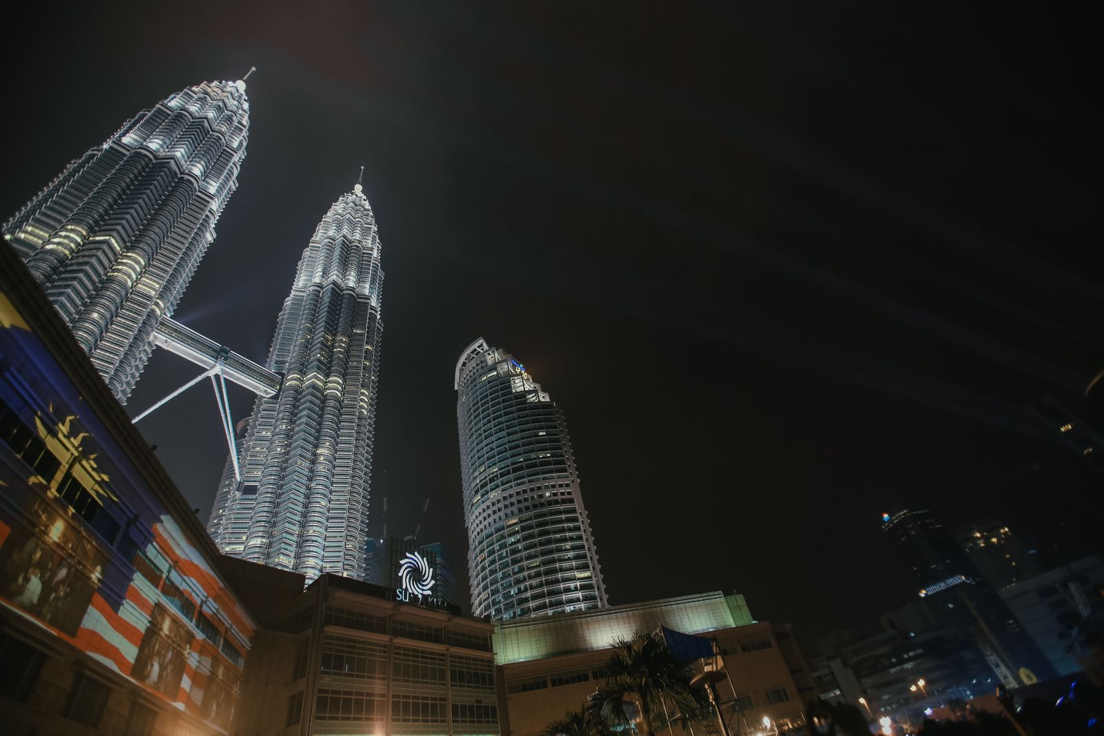 A stunning nighttime view of the Petronas Twin Towers illuminated in Kuala Lumpur, Malaysia.